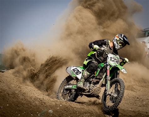 Rider Riding Green Motocross Dirt Bike · Free Stock Photo