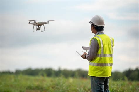 Premium Photo | Construction engineer control drone survey land for real estate development