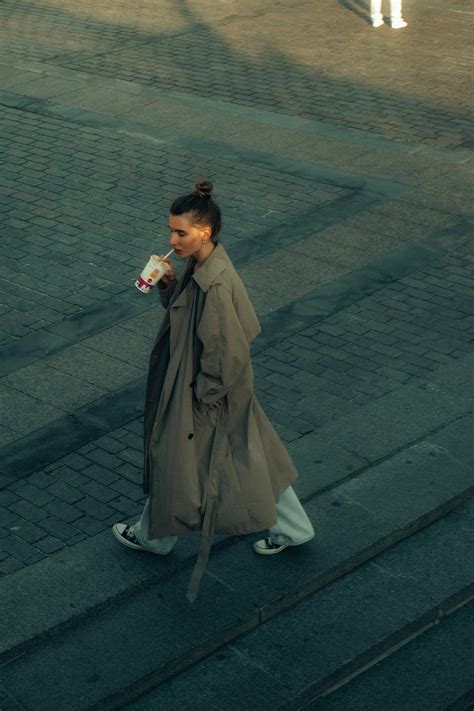 Young stylish woman walking on sidewalk · Free Stock Photo