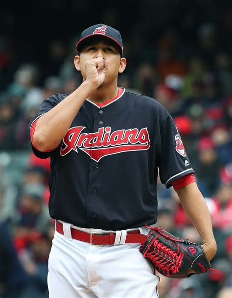 Cleveland Indians Carlos Carrasco tries to keep his hand warm in the first inning pitching ...