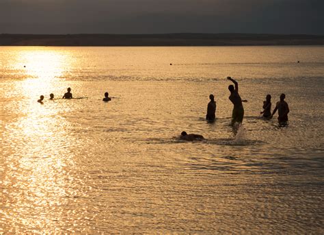 FREE IMAGE: Silhouette Of Young People Playing In The Sea In Sunset | Libreshot Public Domain Photos