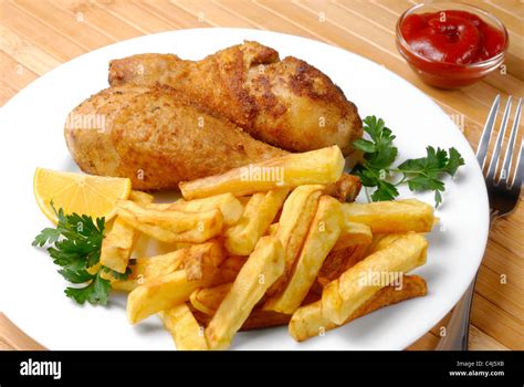 Fried chicken legs and potato chips Stock Photo - Alamy