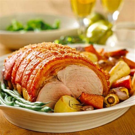 Roast pork leg with crackling, roasted vegetables and apple sauce