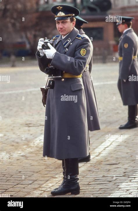 Moscow, Russia. 7th Nov, 1987. A uniformed KGB security guard holding his camera in Red Square ...