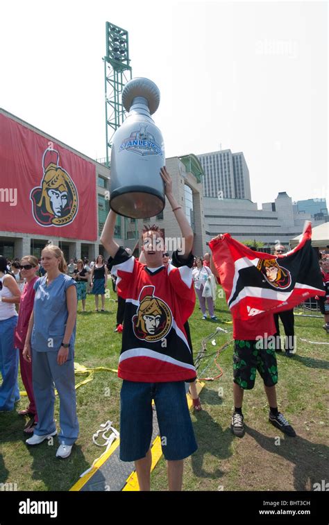 An inflatable Stanley Cup is held high by an Ottawa Senators fan at a ...