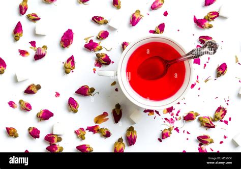 Rose tea in cups with flowers on white background Stock Photo - Alamy