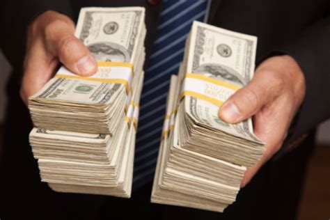 Businessman Handing Over Stacks Of Money Stock Photo - Download Image ...