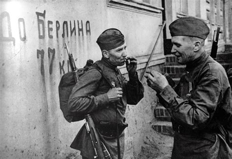 Soviet soldiers near the wall with the inscription “Up to Berlin 77 ...