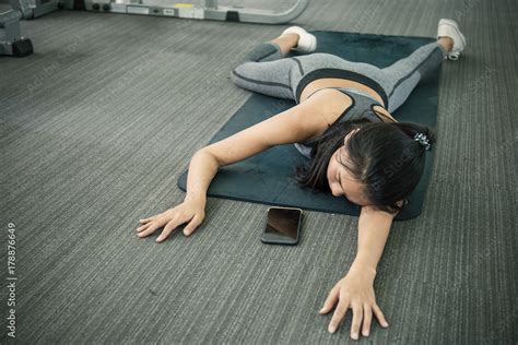 Asian tan woman fainting to the floor during her exercise at the sport ...