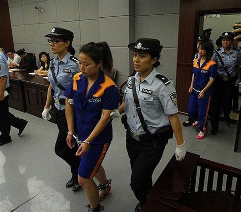 Woman in prisoners suits, handcuffed and shackled are led to court ...