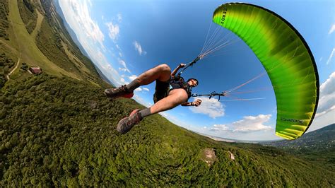 Man flying the paraglider on Behance