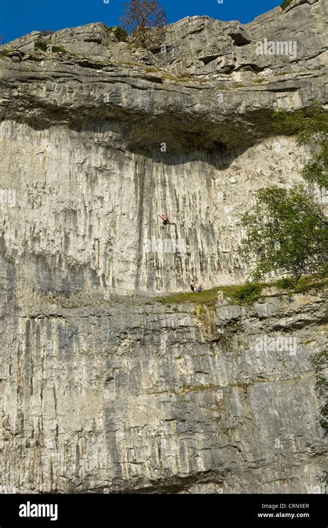 People rock climbing on Malham Cove, a spectacular limestone crag ...