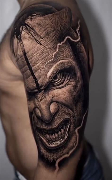 a man's arm with an evil face and lightning coming out of his head