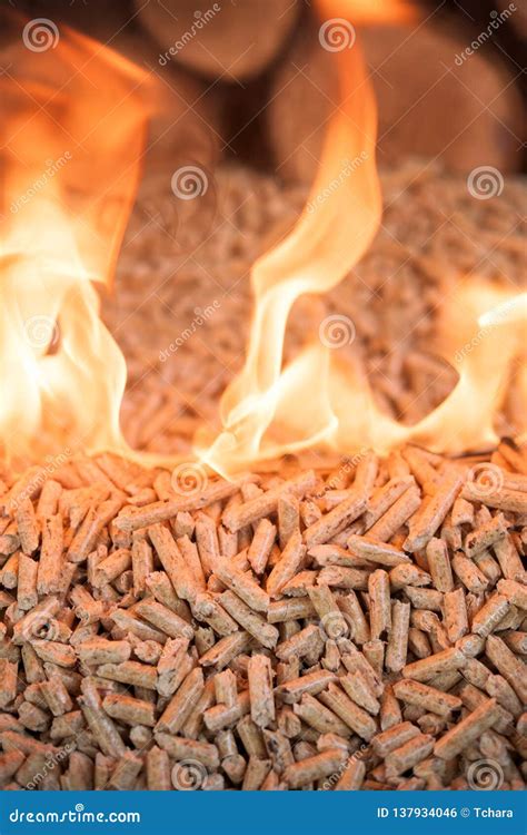 Wooden pellets in fire stock photo. Image of flaming - 137934046