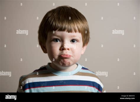 Sad face A young boys makes a sad face expression Stock Photo - Alamy