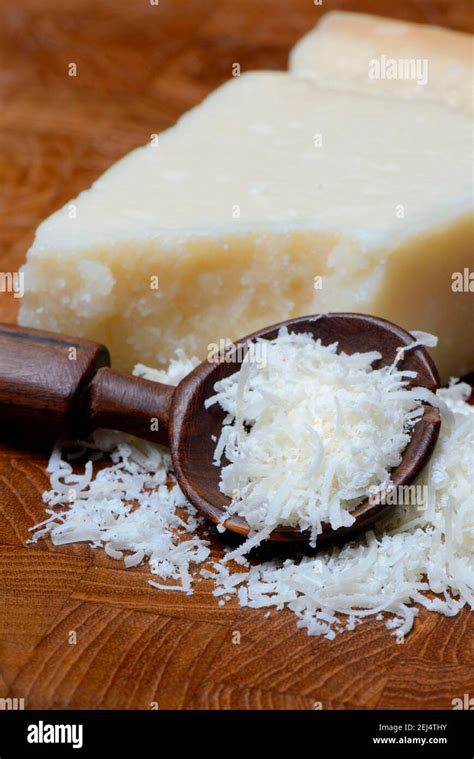 Grated Parmesan cheese and piece of Parmesan cheese, Parmigiano Reggiano Stock Photo - Alamy