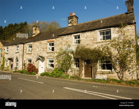 Row of beautiful old cottages from Ashford in the Water, Derbyshire Peak District. Limestone ...