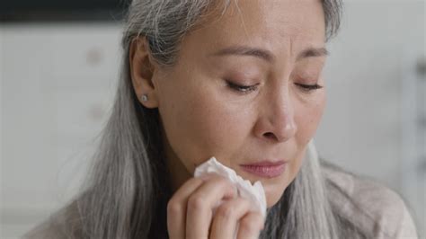 Free stock video - Portrait of sad middle aged woman crying and drying her tears with tissue