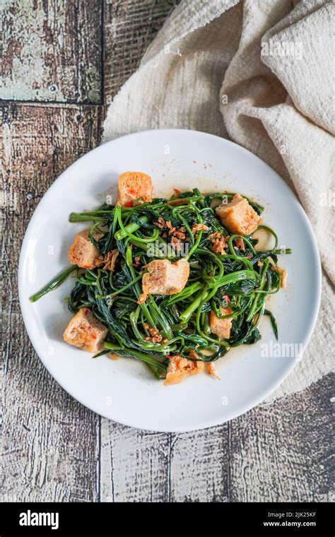 Tumis kangkung tahu : is stir fried water spinach or morning glory with tofu Stock Photo - Alamy