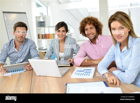 Business meeting around table Stock Photo - Alamy