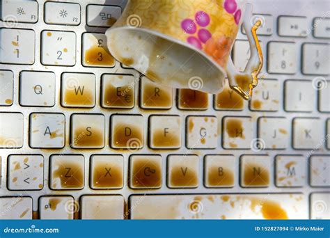 Cup of Coffee Spilling Onto a Laptop Keyboard Stock Photo - Image of close, coffe: 152827094