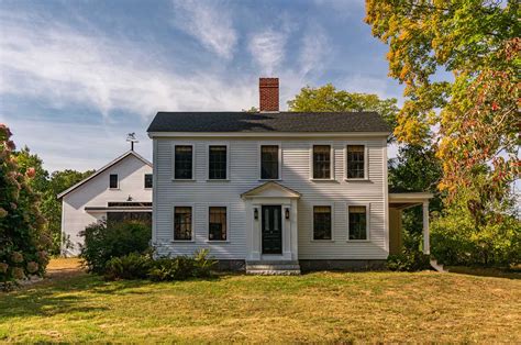 A historical New England farmhouse is restored to its former glory