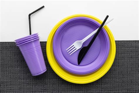 Premium Photo | A set of multi-colored plastic utensils on a black and white background, top view.