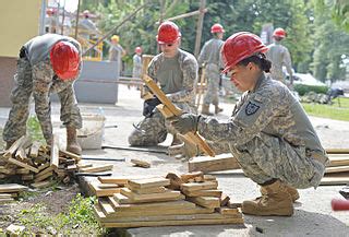 File:Spc. Lounnee Minor helps remove nails from wood forms for ...