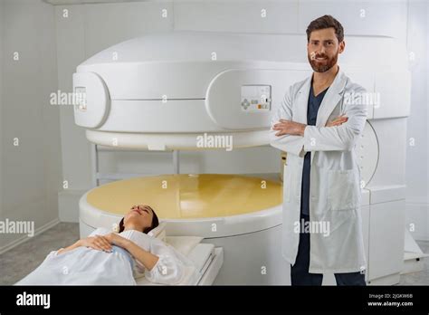 Radiologist on background of MRI or CT or PET Scan with female patient ...