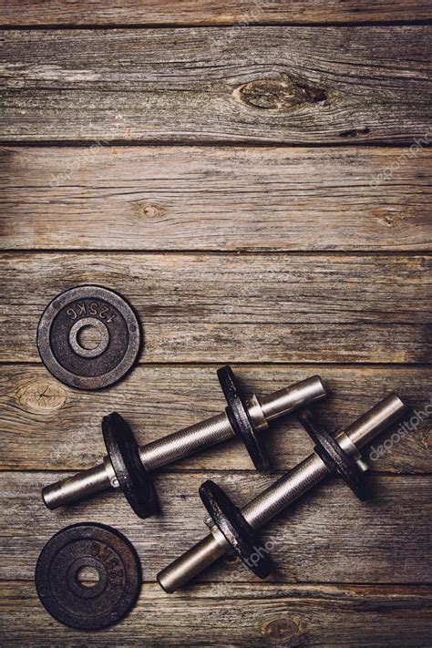 Fitness workout background. Dumbbells on wooden floor Stock Photo by ©Wstockstudio 123359068