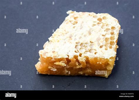 honeycomb section covered in beeswax Stock Photo - Alamy