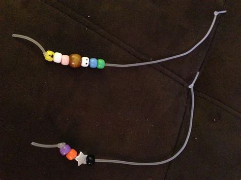 three small beads are attached to a cord on the floor in front of a couch