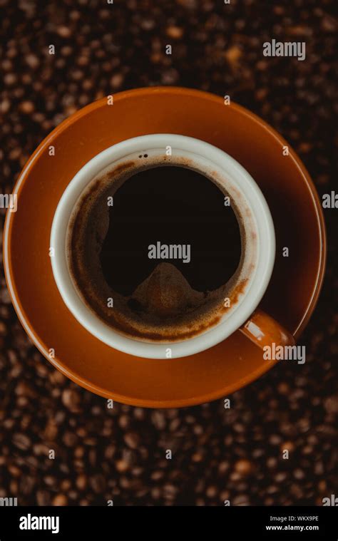 Coffee cup and beans on a background Stock Photo - Alamy