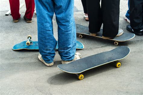 A Group of Teenagers with Skateboards Watching the Competition in a ...