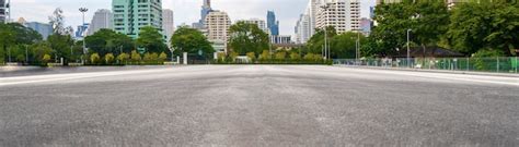 Premium Photo | Empty asphalt road with city in the background