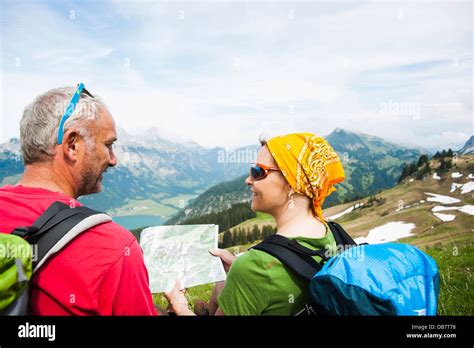 Hiking couple with map Stock Photo - Alamy