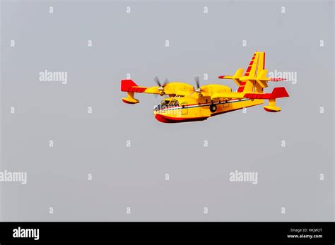 Yellow and red Canadair water bomber, turbo prop firefighting aircraft ...