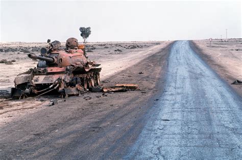 Destroyed Iraqi T-55A main battle tank lies abandoned beside a road at the edge of an oil field ...