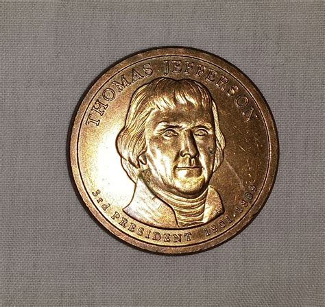 Gold Thomas Jefferson $1.00 dollar coin | Collectors Weekly