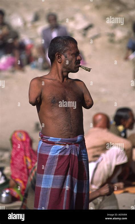 Armless man smoking a cheroot. Khumb Mela festival 2001-Allahabad, Uttar Pradesh, India Stock ...