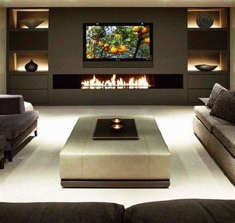 a living room filled with furniture and a flat screen tv mounted on the ...