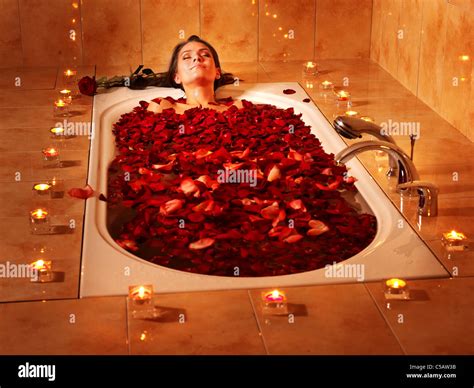 Woman relaxing in bath with rose petal Stock Photo - Alamy