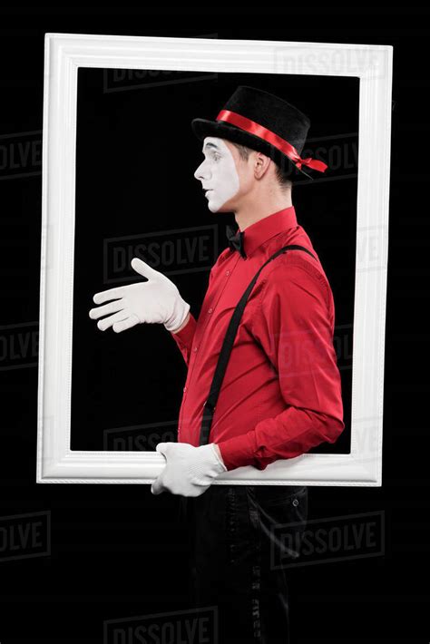 Side view of mime showing hand in frame isolated on black - Stock Photo ...