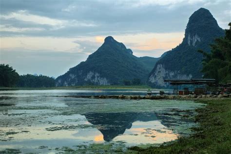 Premium Photo | Karst mountains reflected in li river at sunset