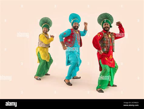 Three Bhangra dancers performing a dance step with hand gestures Stock ...