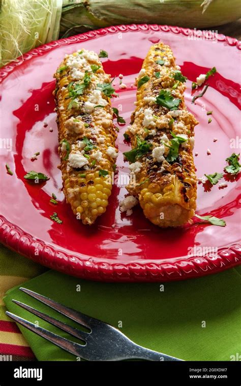 Mexican street corn also known as elote served with chili mayonnaise and cotija cheese Stock ...