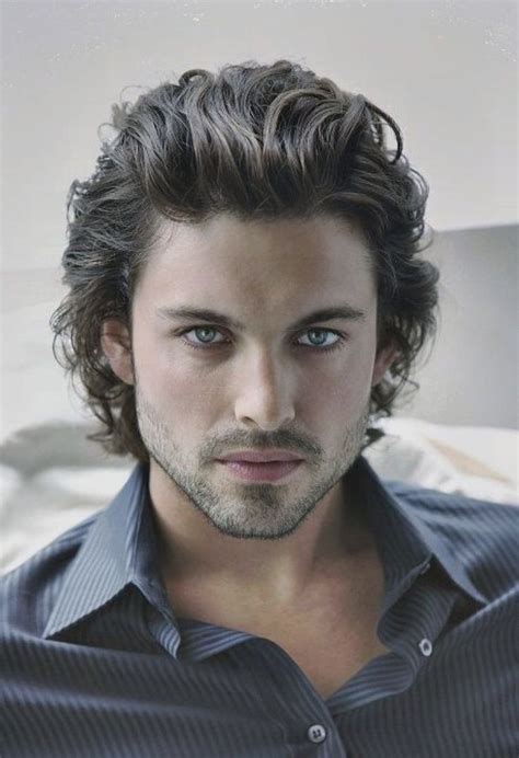 brown-curly-hair-blue-eyes-black-shirt-wavy-hairstyles-for-men | Long ...