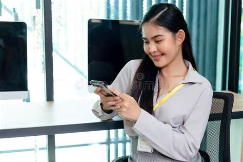 Asian Smiling Businesswoman Using Smartphone in Office Table. Success ...