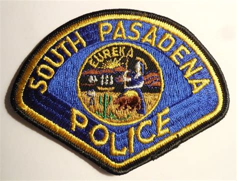 the south pasadena police badge is shown on a white surface with blue and yellow trim