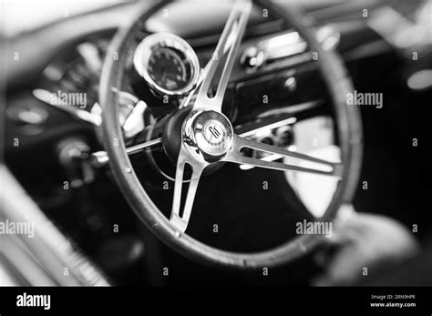 Black and white selective focus photo of a Grant GT steering wheel on an older car in a car show ...